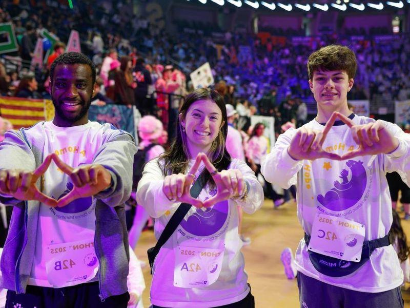 people standing with hands in diamond shape